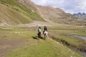 Horse trek through the valley with a view of Mount Kazbek, Georgia